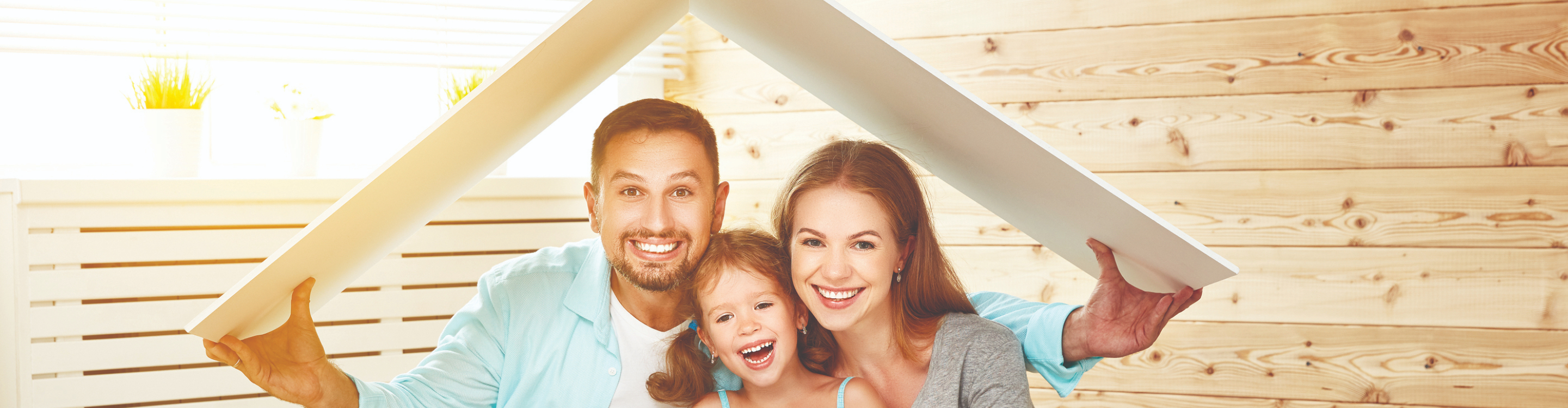 family holding flooring boards